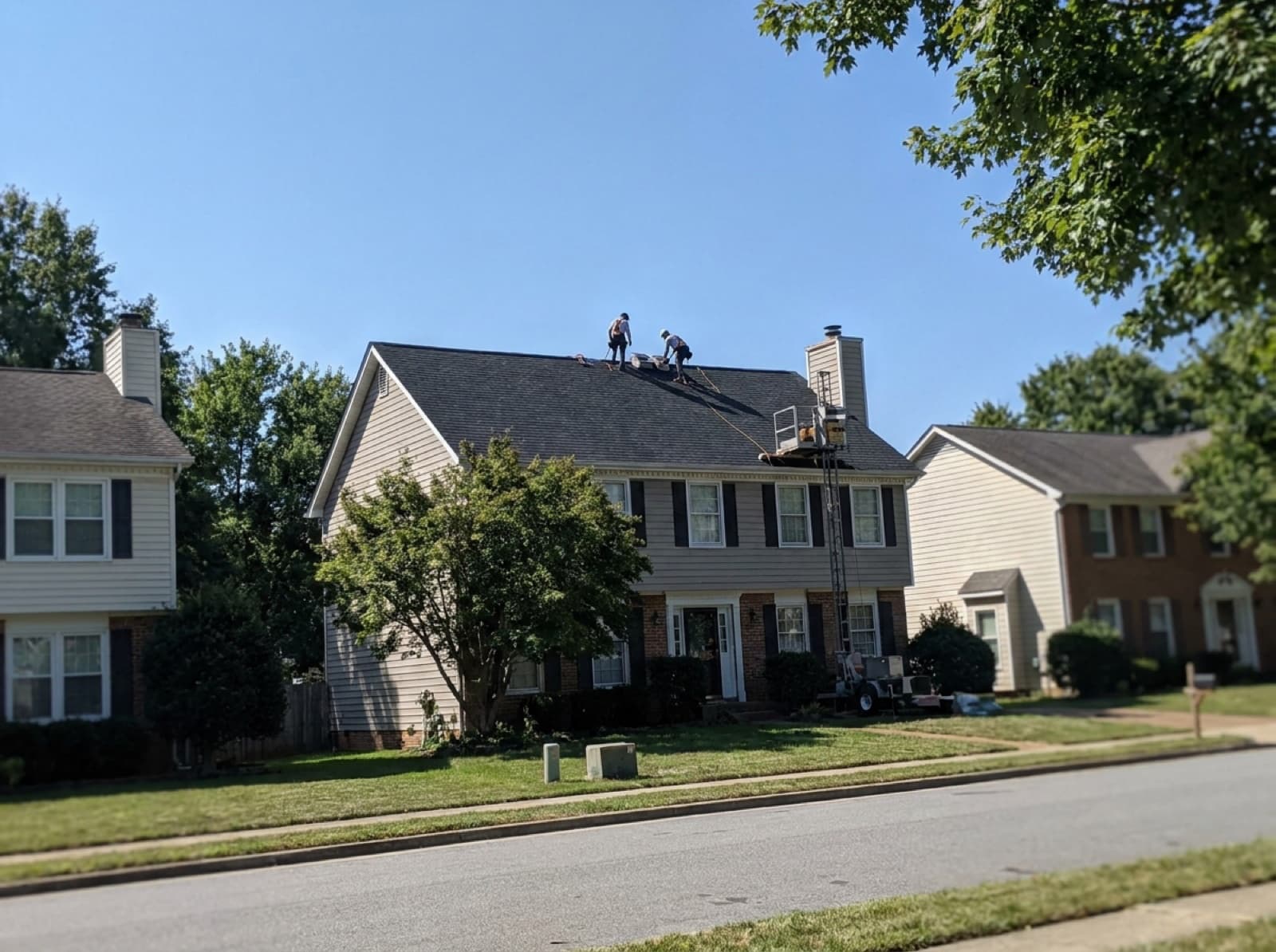 Roofers working on a residential roof